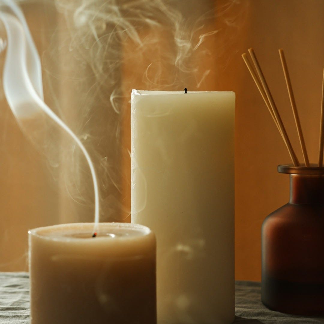 a couple of candles sitting on top of a table a couple of candles sitting on top of a table