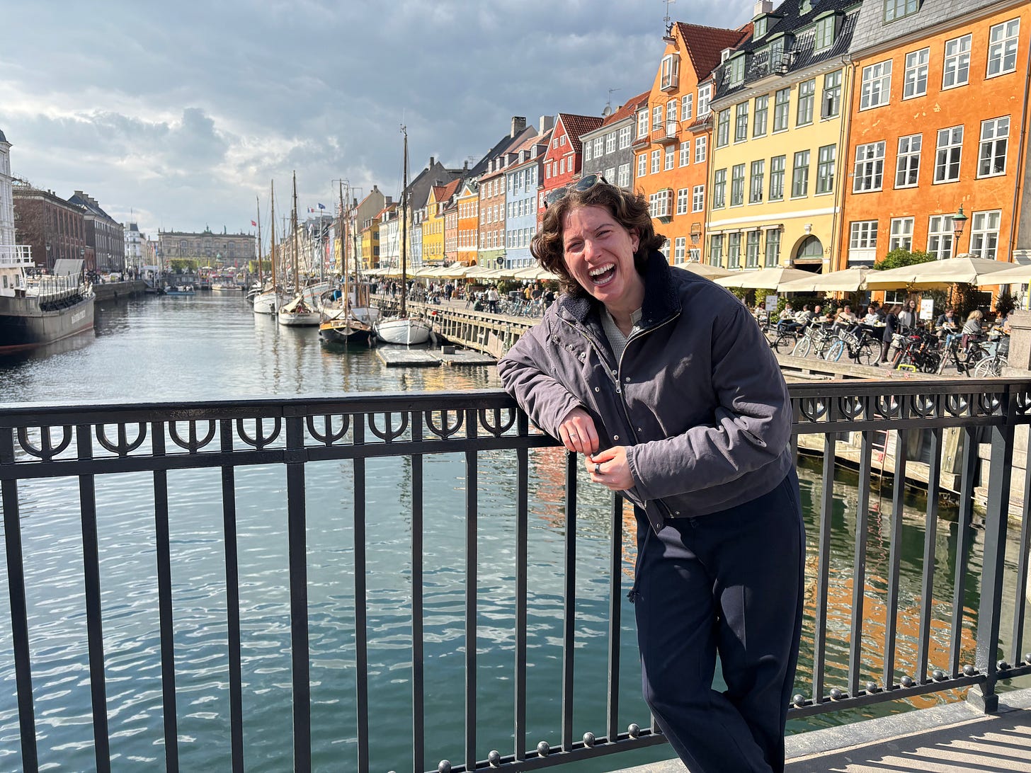 Maeve standing in front of the famous Nyhavn houses laughing