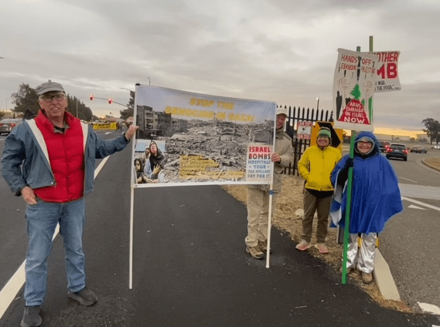 A group of people holding signs

Description automatically generated