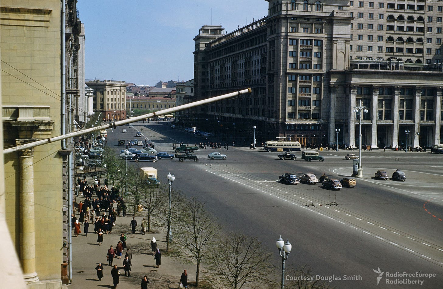 A dynamic snapshot of Manezhnaya ploshchad, Moscow, bustling with activity in the 1950s. A dynamic snapshot of Manezhnaya ploshchad, Moscow, bustling with activity in the 1950s.