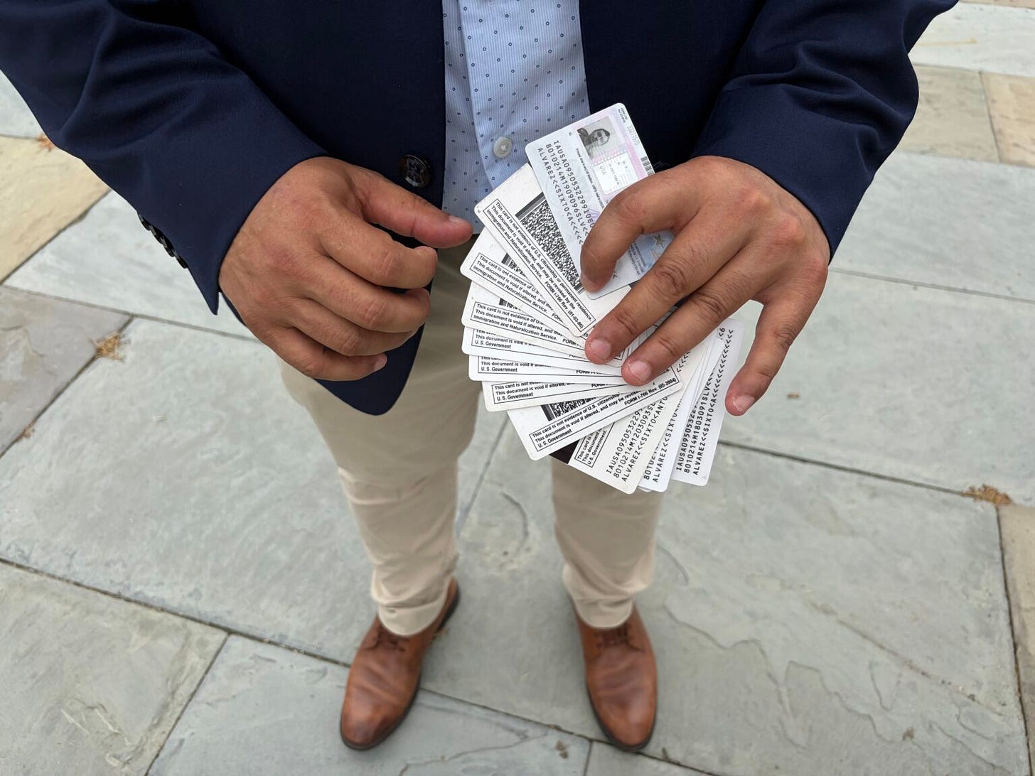 Jose Palma holds the work authorization cards of a Salvadoran member of the National TPS Alliance. The individual has renewed work permits 14 times since Temporary Protected Status was granted for El Salvador in 2001, submitting a background check and fingerprints with each renewal cycle. (Photo by Ariana Figueroa/States Newsroom) Jose Palma holds the work authorization cards of a Salvadoran member of the National TPS Alliance. The individual has renewed work permits 14 times since Temporary Protected Status was granted for El Salvador in 2001, submitting a background check and fingerprints with each renewal cycle. (Photo by Ariana Figueroa/States Newsroom)