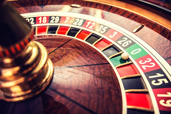 Roulette wheel with ball on zero pocket