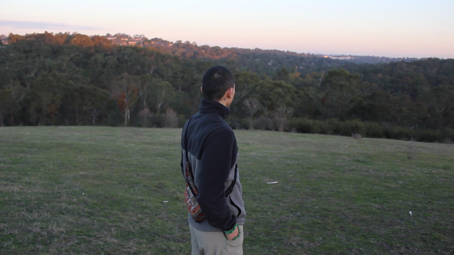 Person on a remote hill during a hike, immersed in natural beauty and silence.