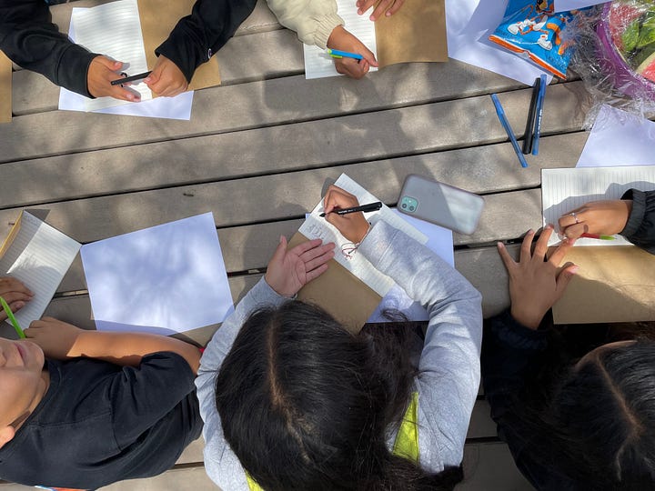 Young people doing poetry activity at Brommer Street Park