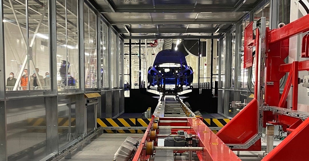 a car being built in a large factory