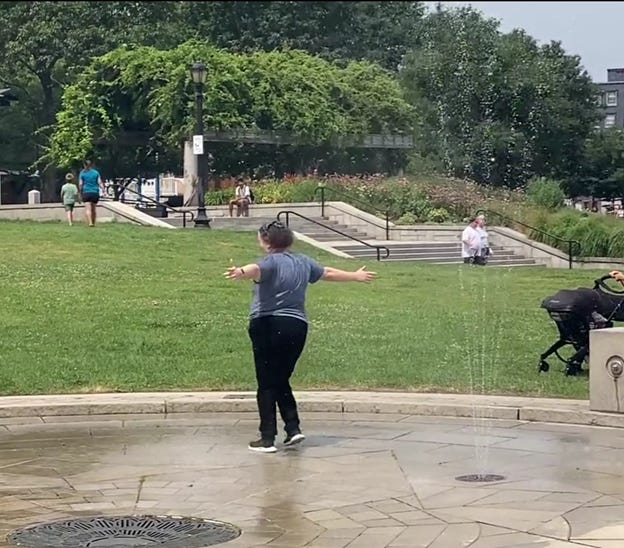 A person standing in a fountain with her arms out

AI-generated content may be incorrect.