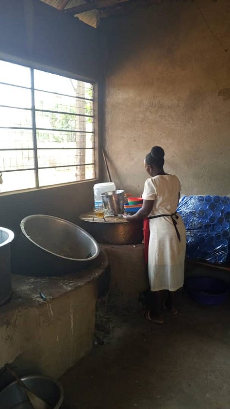 A woman cooking school lunch over a big saucepan, a child eating school lunch from a red plastic bowl, and children in line to receive their free meals at school