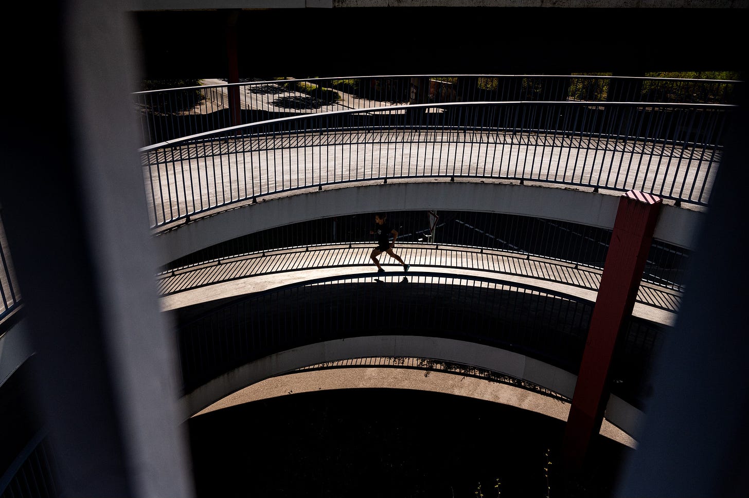Runner running up a loop of concrete