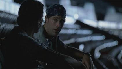 Desmond and Jack sit in a deserted stadium.