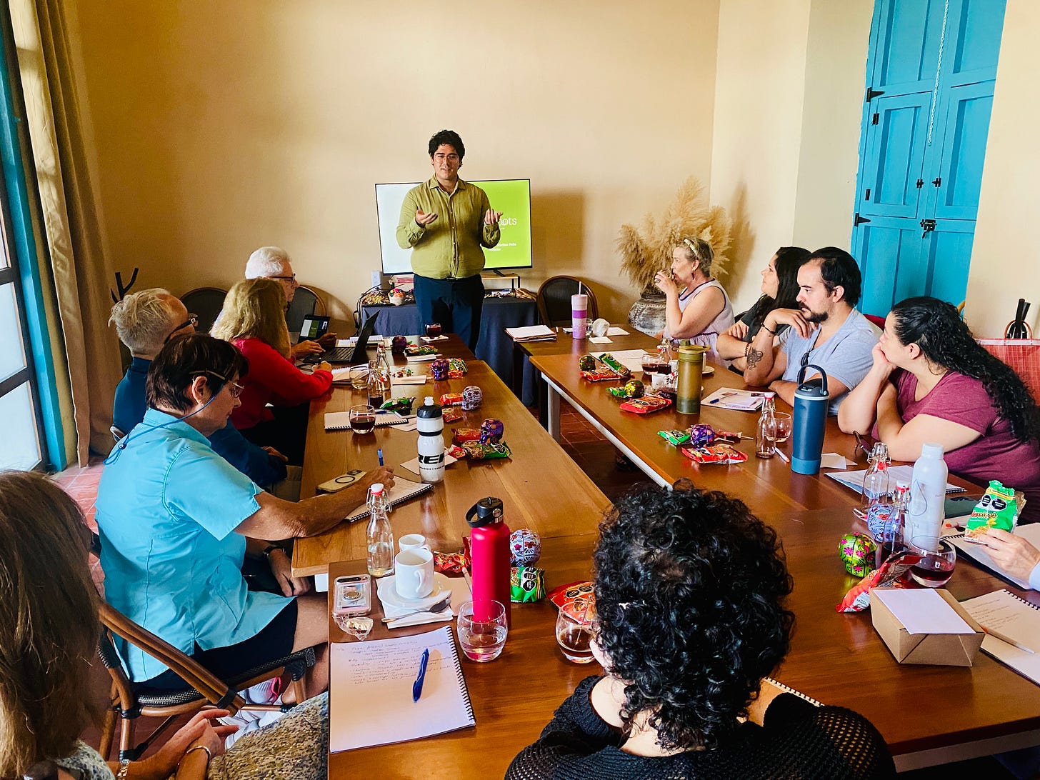Héctor Medina of New Roots Immigration Law presenting to an Expatsi scouting trip group in Mérida