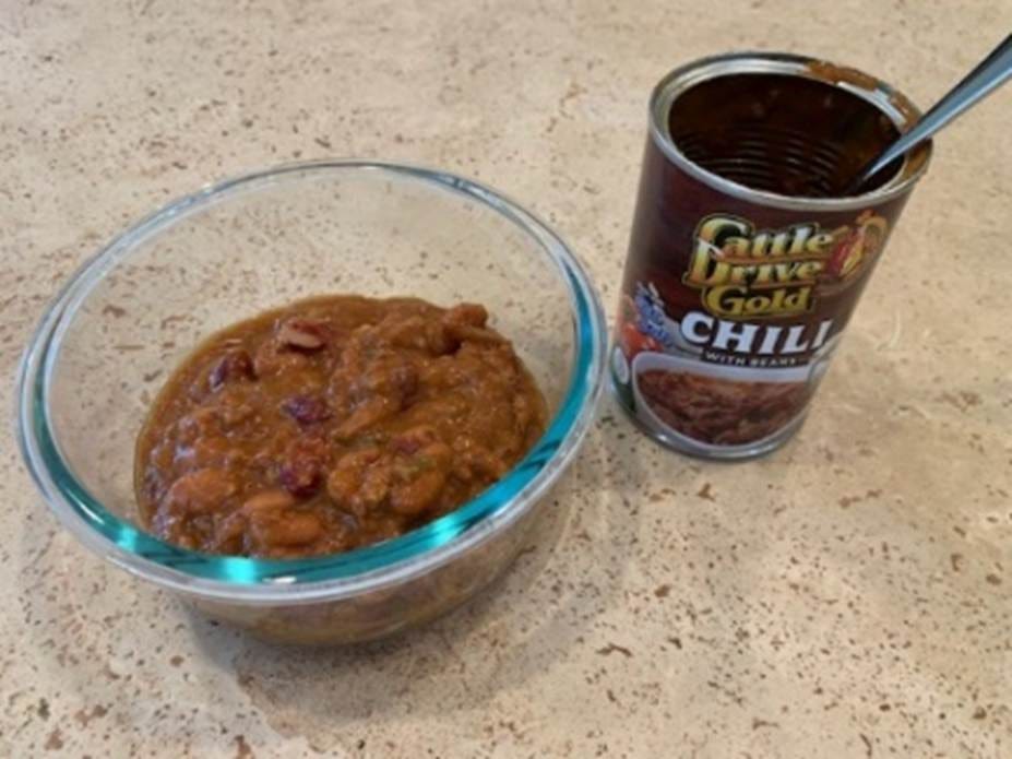 A bowl of food next to a can of chili
Description automatically generated A bowl of food next to a can of chili
Description automatically generated
