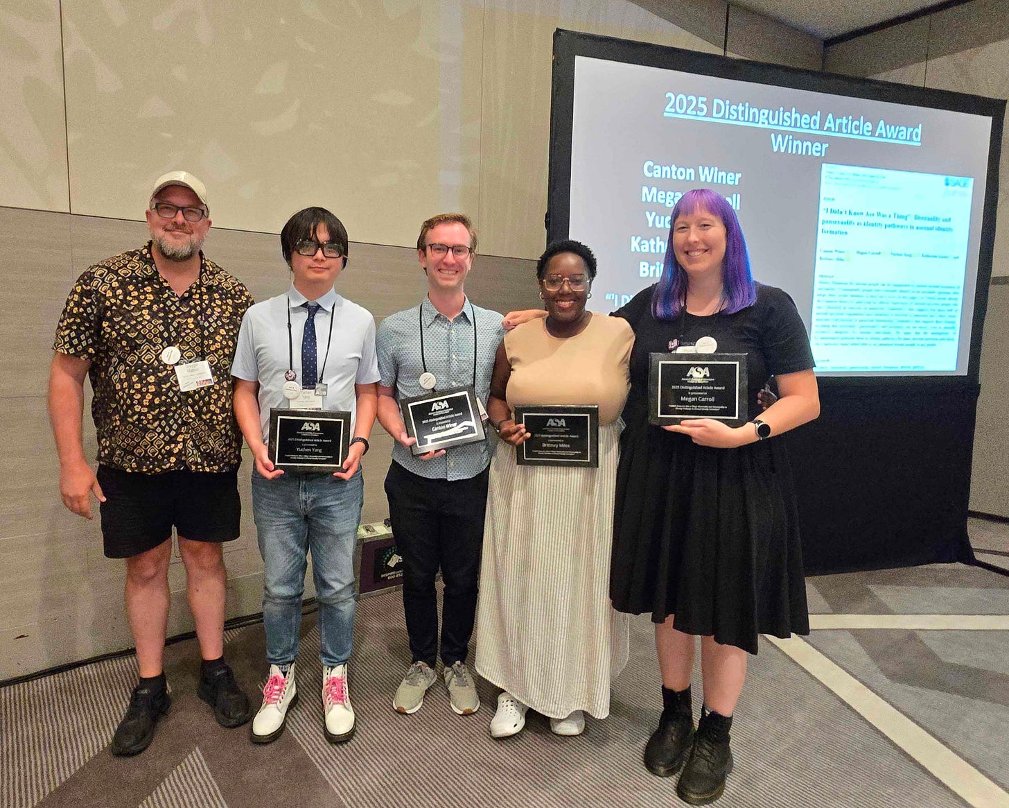 Picture of me and my co-authors with our award plaques.