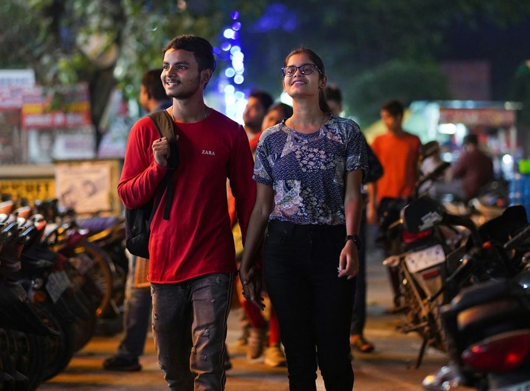 A man and a woman walking down a street A man and a woman walking down a street