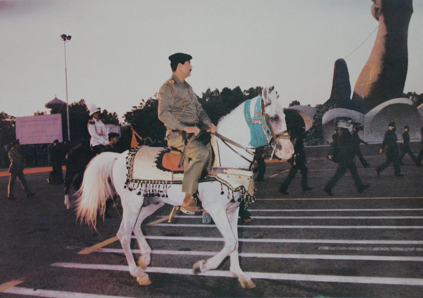 Iraqi dictator Saddam Hussein riding a horse during a parade, 1980's. Iraqi dictator Saddam Hussein riding a horse during a parade, 1980's.