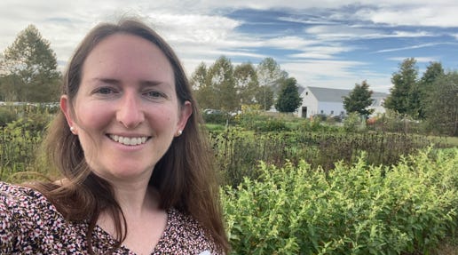 person smiling in a farm field