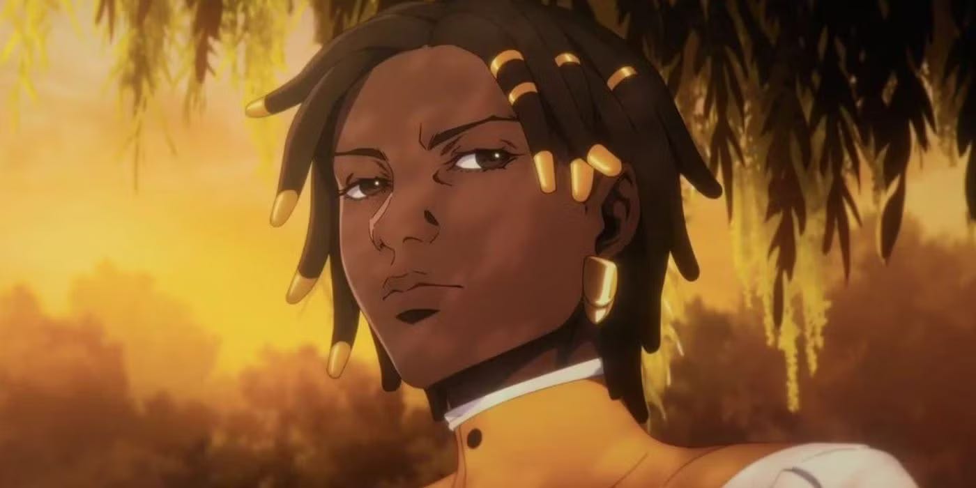 A still from Castlevania Nocture of a close-up of Annette’s face. She’s a dark skin Black young woman with gold, short locs, with some of the locs capped with gold. She has soft, full features but a sharp jawline, and her eyebrows hold some tension as she side-eyes something seriously. She had a gold earring and a high-collared yellow and white button-up blouse. The leaves of a willow tree hang behind her in an orange-gold glow.