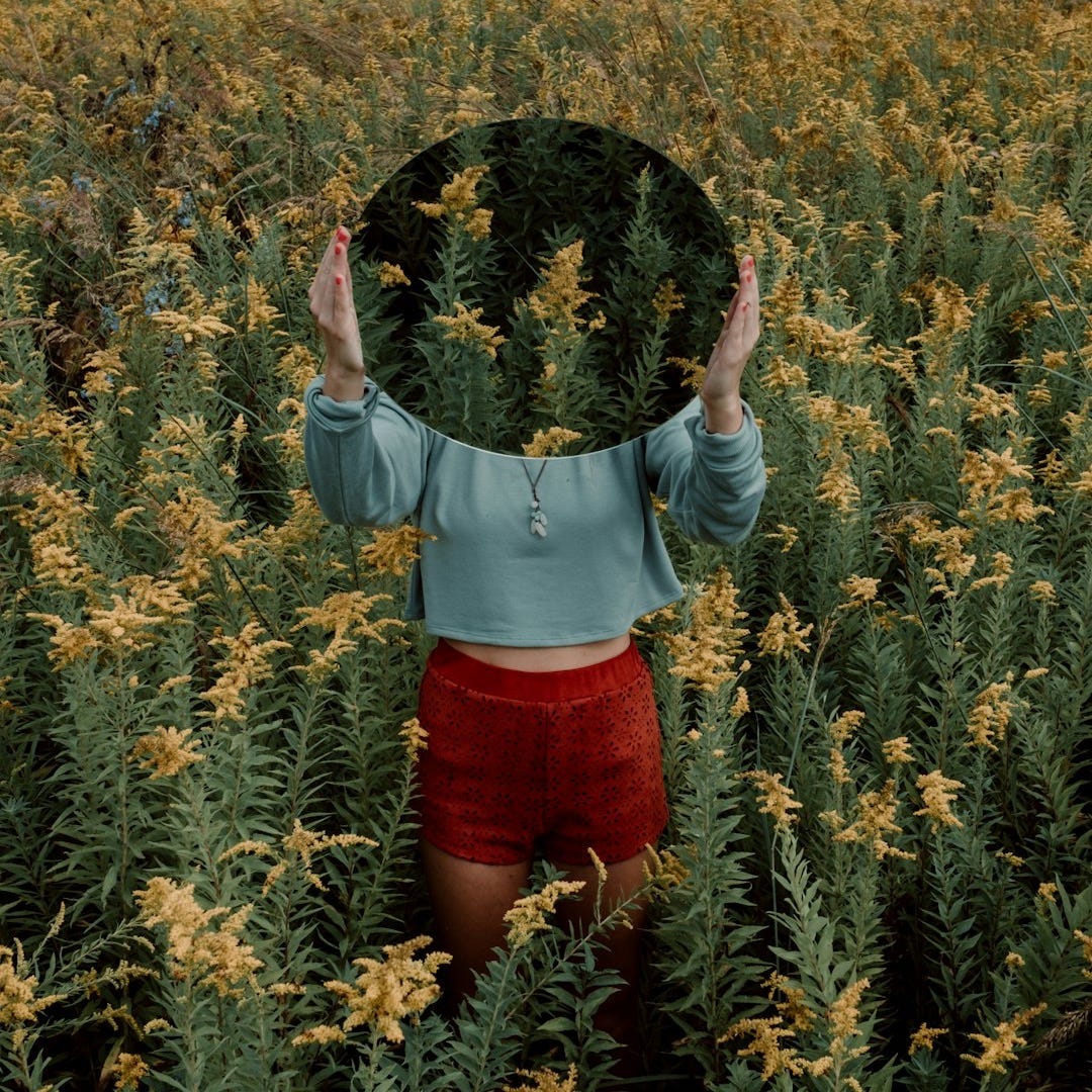 standing woman surrounded by yellow flower field during daytime standing woman surrounded by yellow flower field during daytime