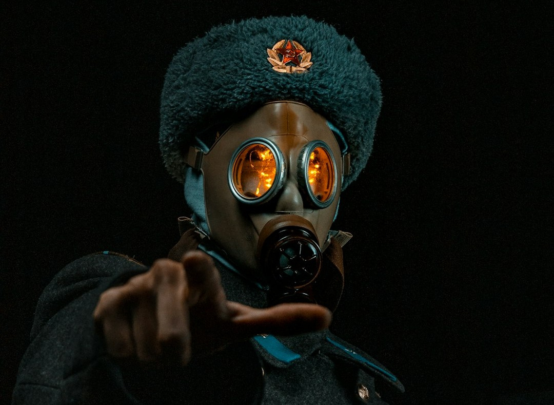 a man in a gas mask pointing at the camera a man in a gas mask pointing at the camera