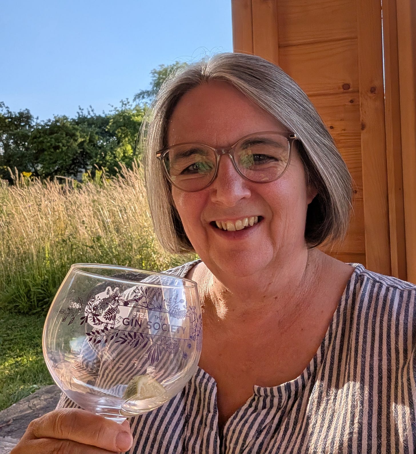 Andrea relaxing with a gin and tonic in a friend's summer house, enjoying a peaceful evening of hospitality before a visit to Gladstone Pottery Museum. Andrea relaxing with a gin and tonic in a friend's summer house, enjoying a peaceful evening of hospitality before a visit to Gladstone Pottery Museum.