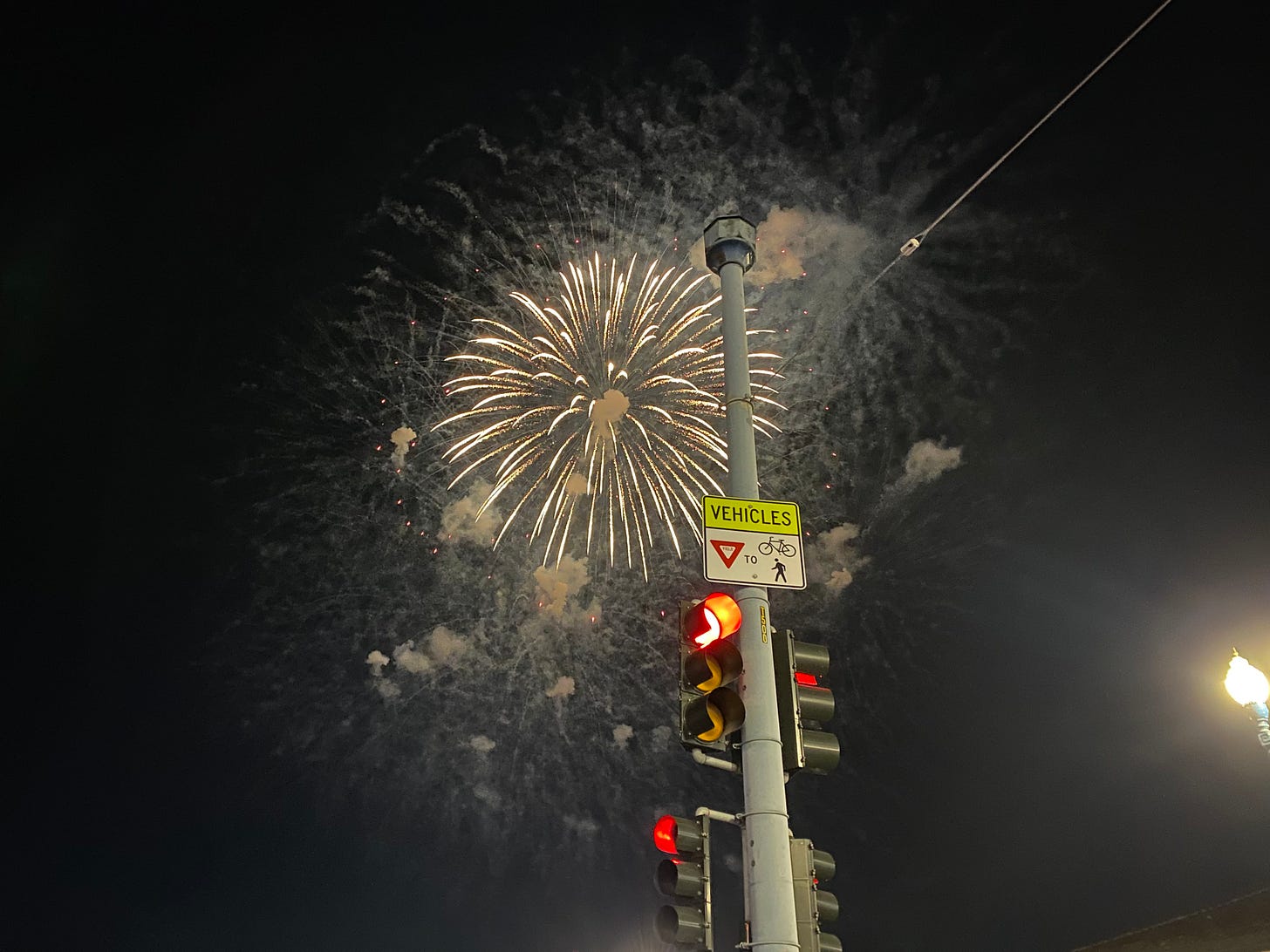 fireworks and a traffic pole fireworks and a traffic pole