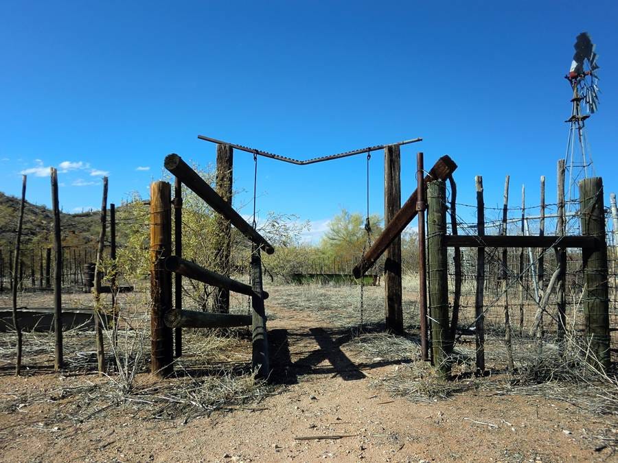 A gated fence in a desert

AI-generated content may be incorrect.