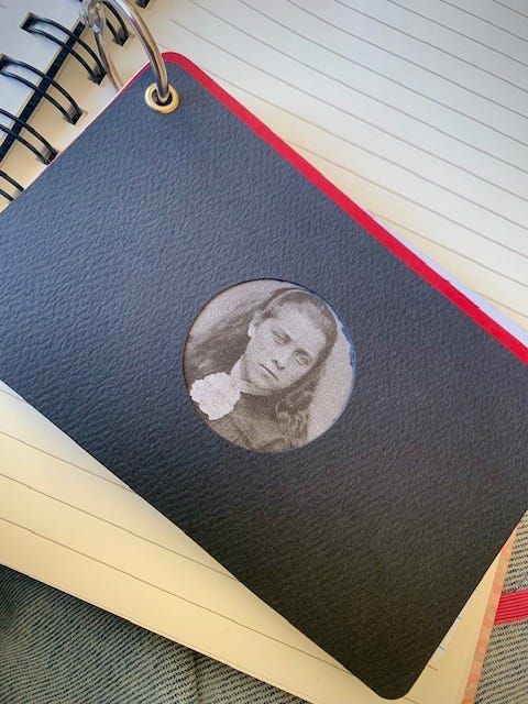 A gallery of four images includes: three small handbound notebooks and a vintage typewriter