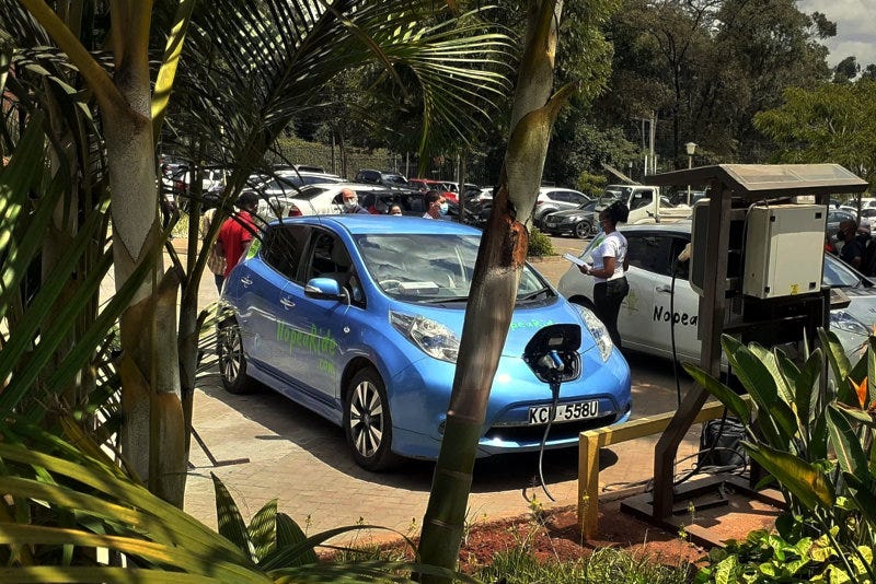 A Nopea Ride taxi plugged into a charging station.