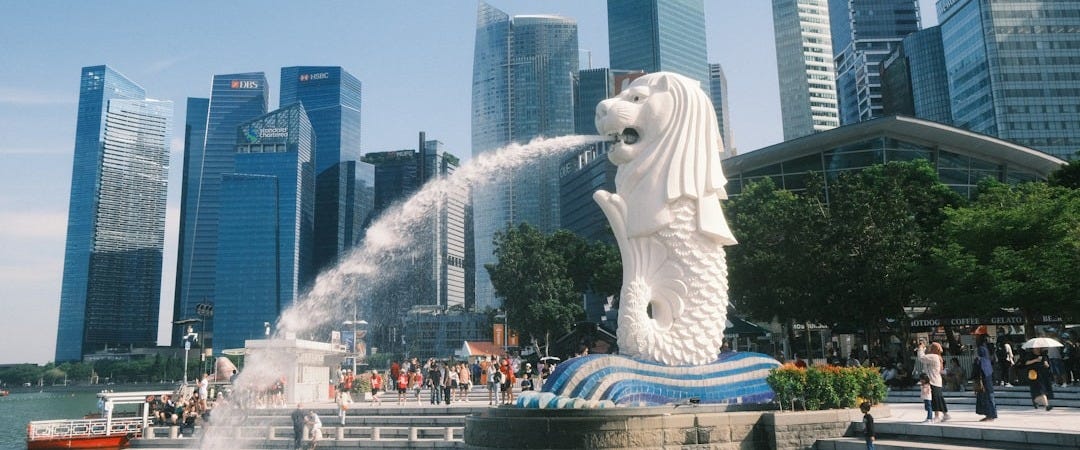 The Merlion statue spraying water into the bay before the Singapore skyline