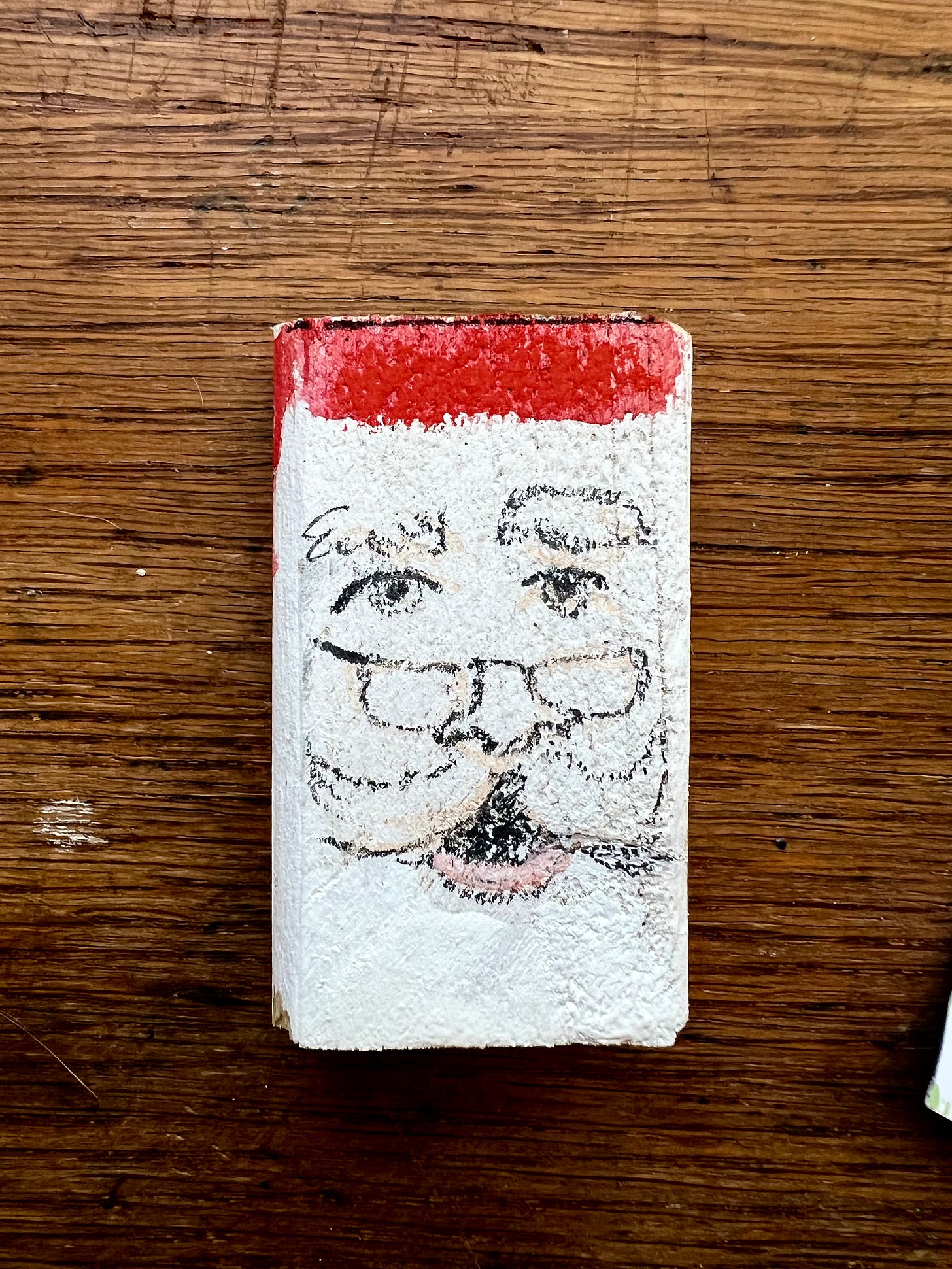santa drawn on a tiny block of wood