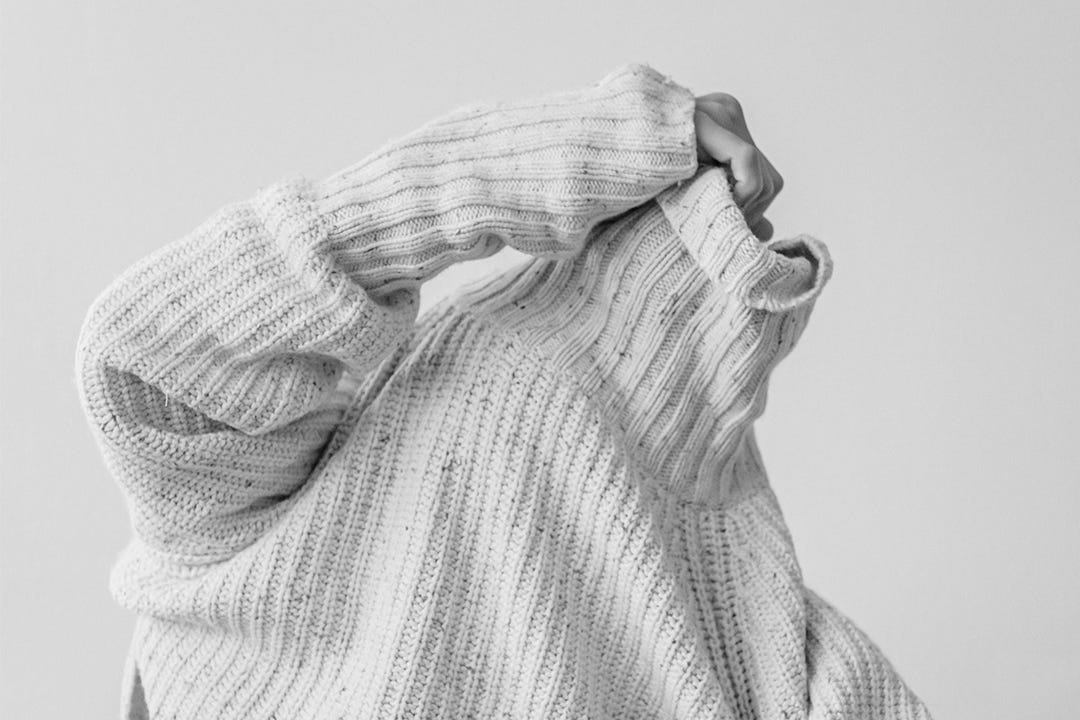 Person tries to take sweater off Person tries to take sweater off
