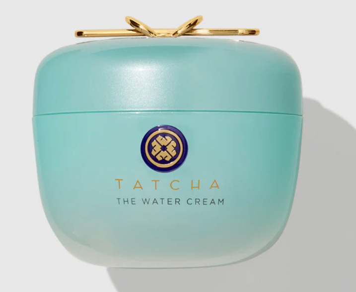 Close-up of Tatcha The Dewy Skin Cream showing the rich, purple-hued clinical texture and the gold applicator scoop.