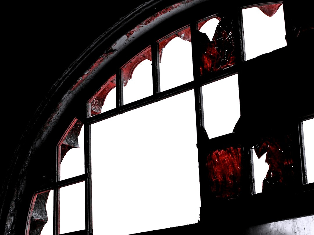 Broken window with dark, ominous framing Broken window with dark, ominous framing