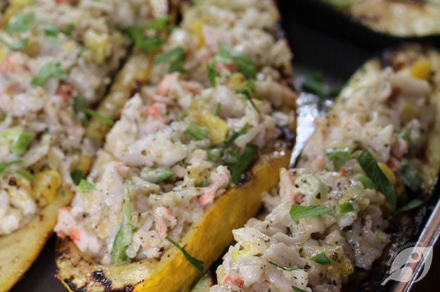 Showing the filled zucchini and summer squash halves before placing them on the grill. Showing the filled zucchini and summer squash halves before placing them on the grill.