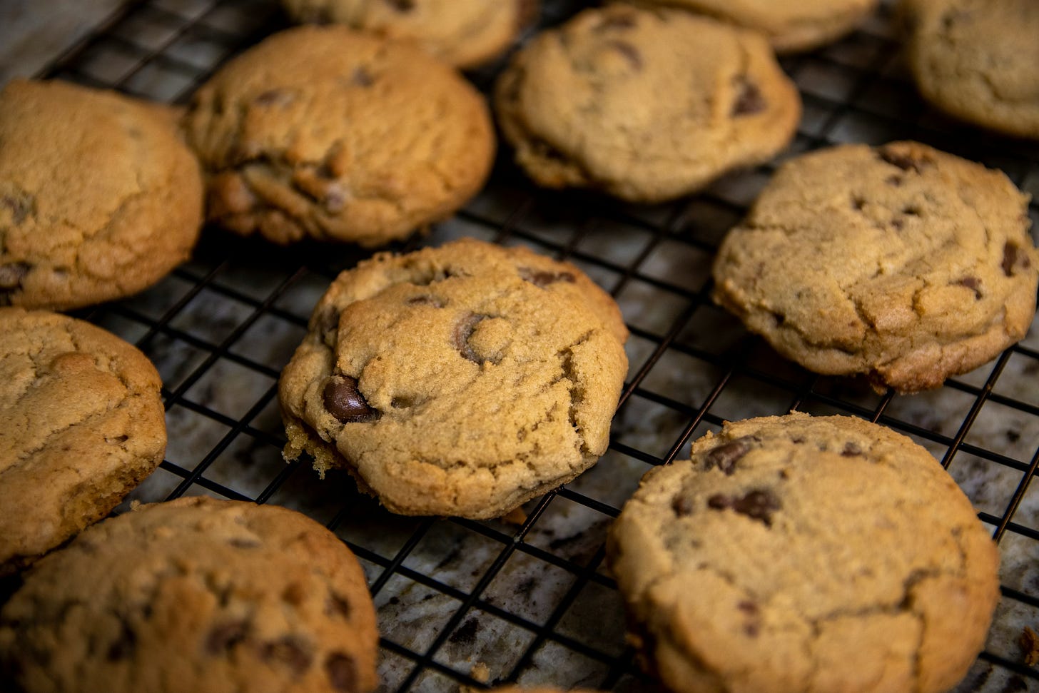 Baked chocolate chip cookies on a cooling rack