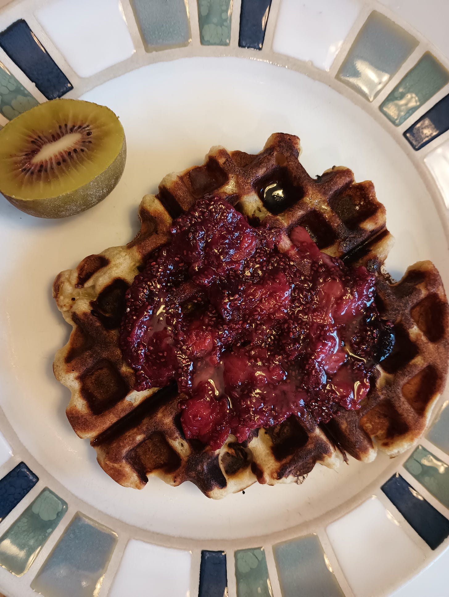 waffle with chia jam and kiwi half.