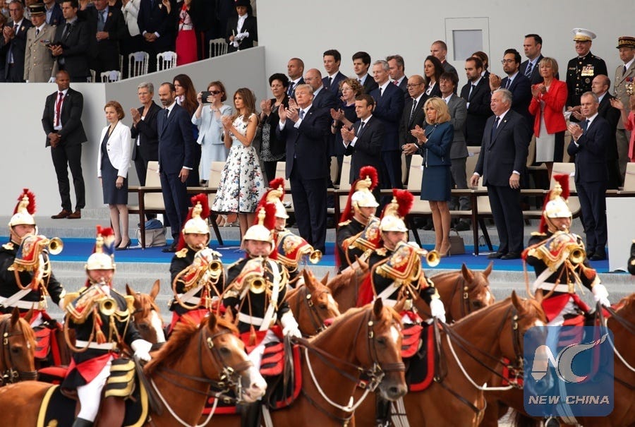 A group of people standing in front of a group of people

Description automatically generated