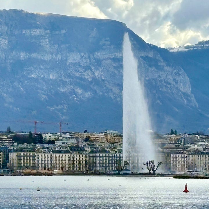 Geneva’s Jet d’Eau, soaring above Lake Geneva with the mountains beyond.