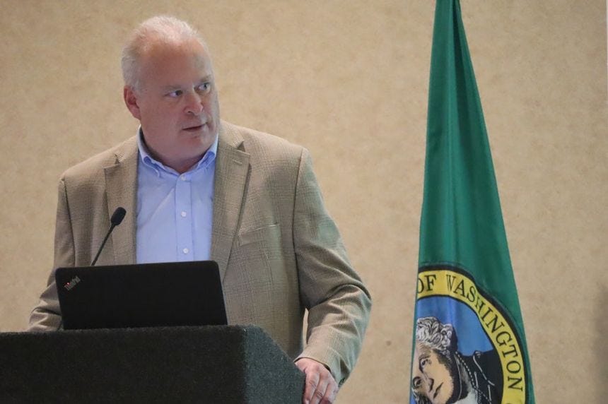 caption: Washington State Rep. Jim Walsh speaks at a meeting of the Washington State Republican Party, ahead of being elected chair of the group in August 2023.