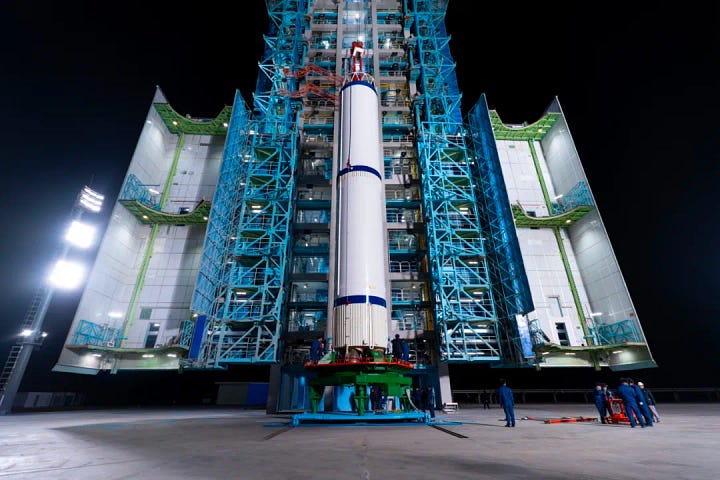 The first-stage, second-stage, and fairing for the Long March 2C launch vehicle heading to and being stacked ahead of the launch mission.