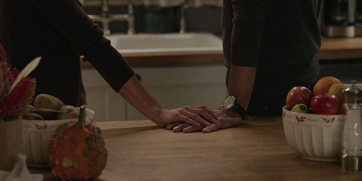 Cassie and Kevin touching hands at Walker ranch kitchen butcher block table. Cassie and Kevin touching hands at Walker ranch kitchen butcher block table.