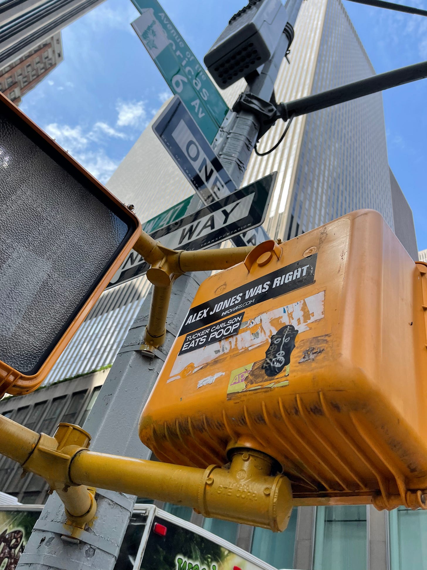 Photo of NYC street sign with a sticker that says “Tucker Carlson Eats Poop.”