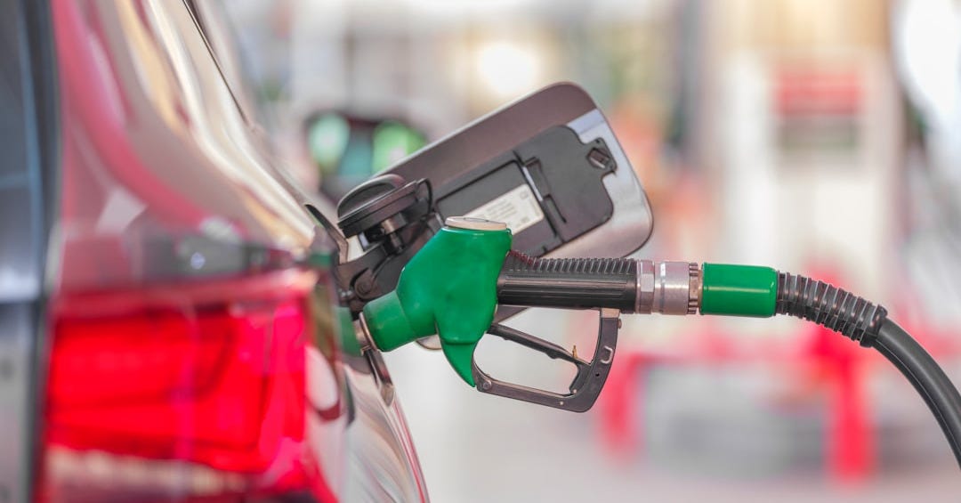 a gas pump is connected to a car at a gas station