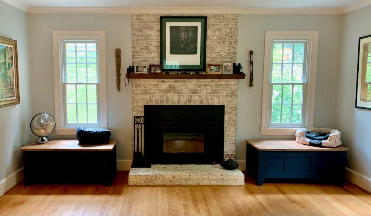 Living room with storage boxes on each side of a fireplace.