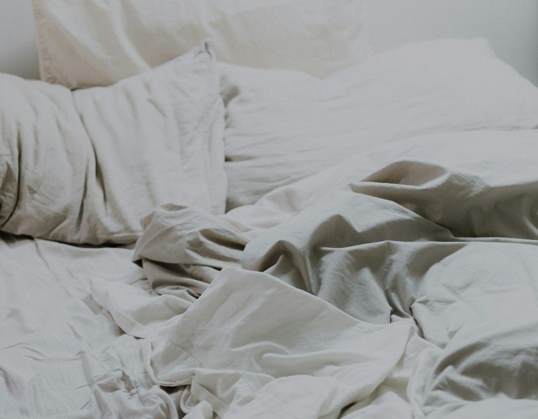 white pillows and bed comforter
