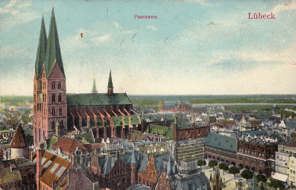 Old coloured postcard showing Lübeck's Marienkirche looming over the town hall.