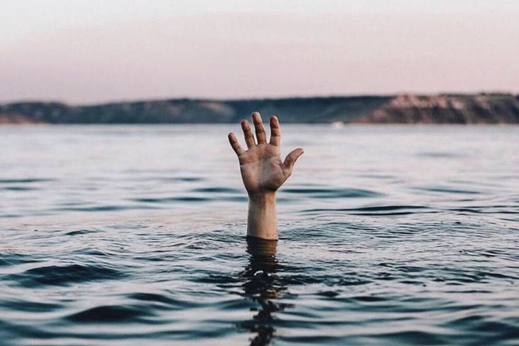 This may contain: a person's hand is submerged in the water This may contain: a person's hand is submerged in the water