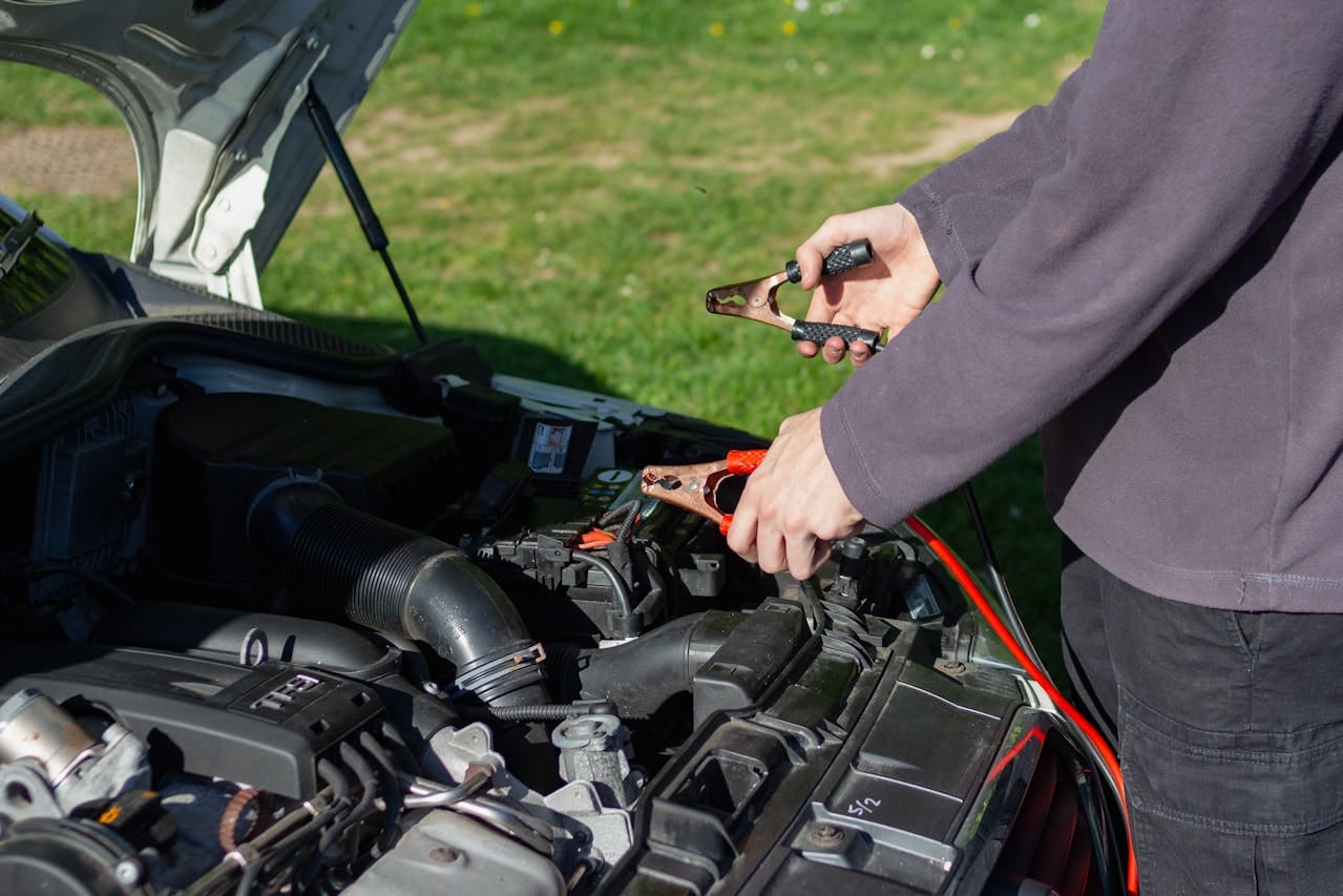 man jumpstarting a car