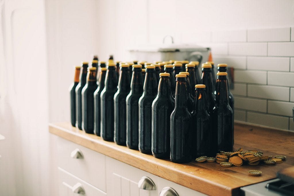 2 rows of capped dark glass bottles sitting on a brown shelf as example of a possible smuggling scene 2 rows of capped dark glass bottles sitting on a brown shelf as example of a possible smuggling scene