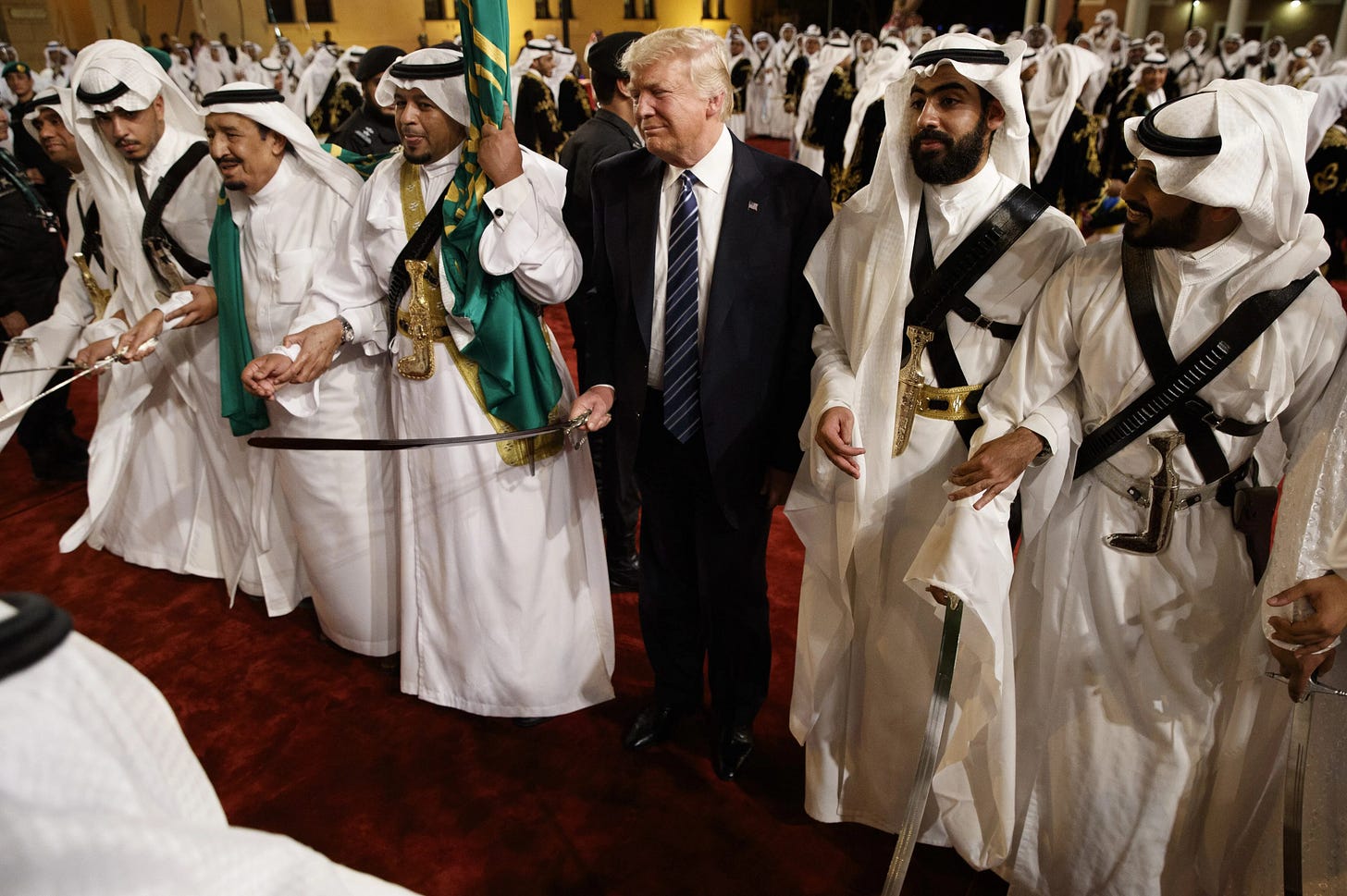President Donald Trump holds a sword and sways with traditional dancers during a welcome ceremony at Murabba Palace in Riyadh, Saudi Arabia, last May. 