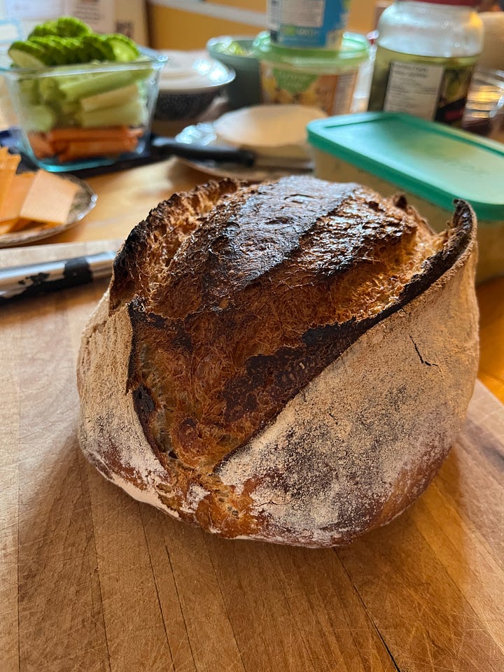four images: 1 a jar of bubbly sourdough starter, 2 a tub of risen sourdough, 3, a loaf of bread on a cutting board, 4 the same loaf cut into pieces